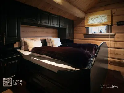 a bedroom with a bed in a log cabin at Luxury Cabin at Nesfjellet with sauna, bbq, close to ski & golf in Nes i Ådal