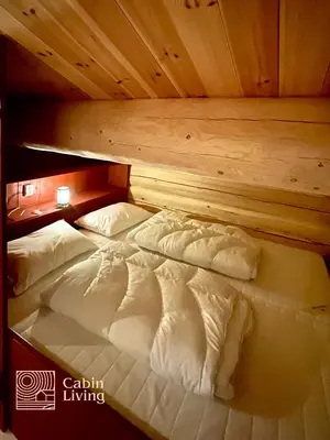 two twin beds in a room with wooden ceilings at Luxury Cabin at Nesfjellet with sauna, bbq, close to ski & golf in Nes i Ådal