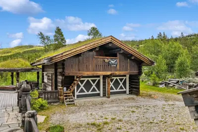 a log cabin with a grass roof at Luxury Cabin at Nesfjellet with sauna, bbq, close to ski & golf in Nes i Ådal