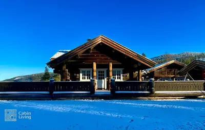 a log cabin with snow in front of it at Luxury Cabin at Nesfjellet with sauna, bbq, close to ski & golf in Nes i Ådal
