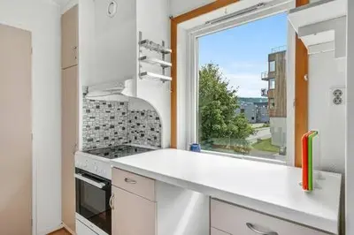 a kitchen with a window and a white counter top at Fully equipped independent apartment near NTNU,Lerkendal og center in Trondheim