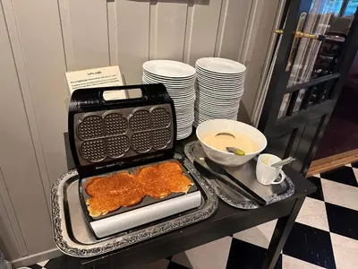 a table with a tray of food on a table with plates at Hofslund Apartments in Sogndal