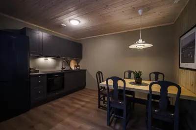 a kitchen with a table and chairs in a room at Bjorli Fjellstuer - by Classic Norway Hotels in Bjorli