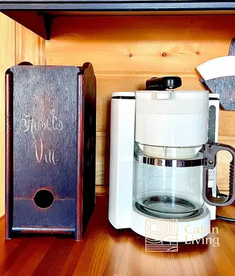 a coffee maker and a book on a table at Cozy apartment with a view and ski inout Hafjell in Hafjell