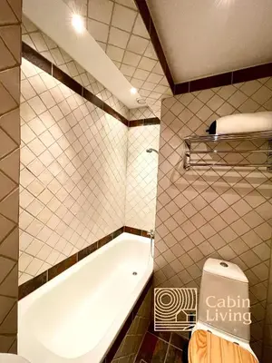 a bathroom with a bath tub and a toilet at Cozy apartment with a view and ski inout Hafjell in Hafjell