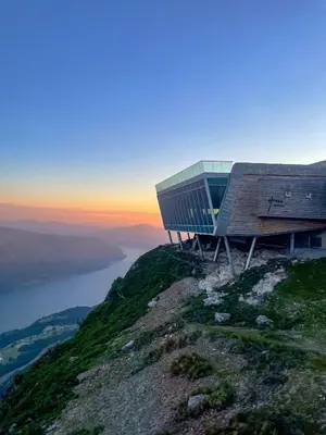 a building on the top of a mountain with the sunset at Loen Apartments in Loen
