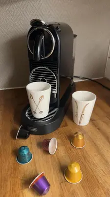 a coffee maker with two cups on a table at Hyggelig leilighet i sentrum in Hemsedal