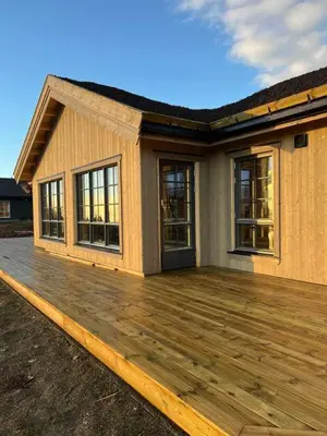 a house with a wooden deck in front of it at Aurdalsåsen panorama in Aurdal