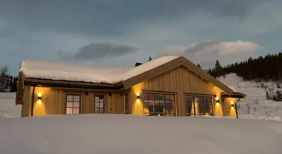 a house with a pile of snow in front of it at Aurdalsåsen panorama in Aurdal