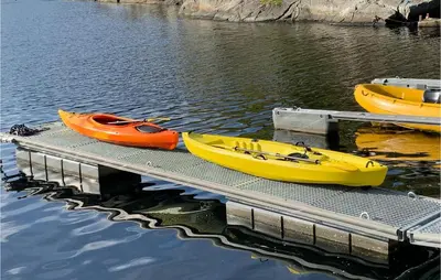 three boats sitting on a dock in the water at 3 Bedroom Lovely Home In Hebnes in Hebnes