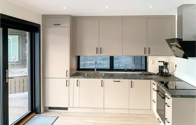 a kitchen with white cabinets and a sink at 3 Bedroom Lovely Home In Hebnes in Hebnes
