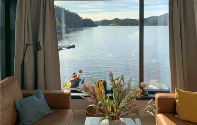 a room with a large window with a view of a lake at Amazing Home In Hebnes With Wifi in Hebnes