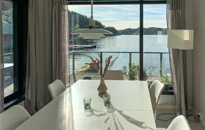 a white dining room table with a view of a lake at Amazing Home In Hebnes With Wifi in Hebnes