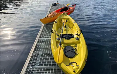 two kayaks are parked on a dock in the water at Amazing Home In Hebnes With Wifi in Hebnes