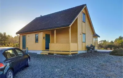 a small house with a car parked in front of it at 4 Bedroom Stunning Home In Auklandshamn in Tjernagel