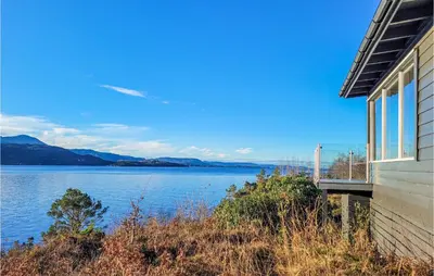 a house with a view of a body of water at 4 Bedroom Lovely Home In Nordtveitgrend in Hjartåker