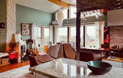 a living room with a table and some windows at Cozy Home In Vevang With Sauna in Vevang