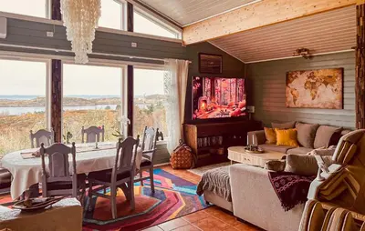 a living room with a table and a couch at Cozy Home In Vevang With Sauna in Vevang
