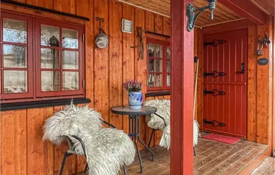 a room with a table and chairs in a cabin at 3 Bedroom Lovely Home In Vinstra in Vinstra