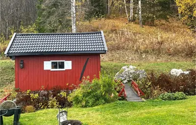 a red shed in the middle of a field at Lovely Home In Bjoneroa With Wifi in Bjoneroa