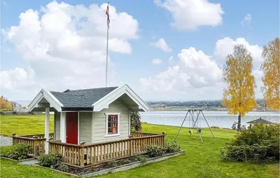 a small house with a flag on top of it at Lovely Home In Bjoneroa With Wifi in Bjoneroa