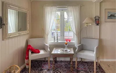 a living room with two chairs and a table and a window at Lovely Home In Bjoneroa With Wifi in Bjoneroa