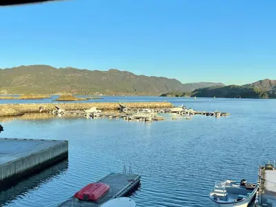a marina with boats and a dock on the water at 6 person holiday home in Huglo-By Traum in Nordhuglo