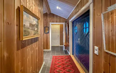 a hallway of a house with a door and a rug at Beautiful Home In Sjusjøen With Wifi in Sjusjøen