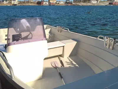 a boat sitting in the middle of the water at 12 person holiday home in Selje-By Traum in Selje