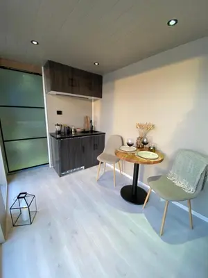 a kitchen and dining room with a table and chairs at Ocean View Stad in Barmen