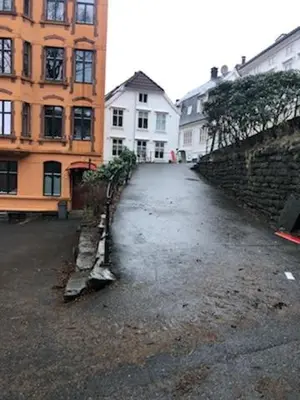 an empty street in a city with buildings at Fløyen Apartment in Bergen