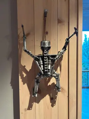 a metal skeleton hanging from a wall at Astonishing Mountain Lodge at the top of Gaustablikk, 25m2 west facing terrace, 3 bedrooms in Gaustablikk