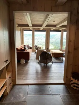 a living room with a couch and a table at Beautifully styled mountain lodge with high standards, 10 minutes from Geilo in Geilo