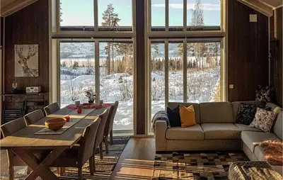 a living room with a table and a couch at 3 Bedroom Gorgeous Home In Brøttum
