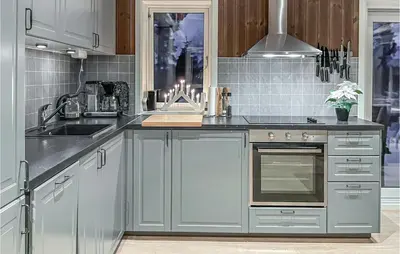 a kitchen with gray cabinets and a stove top oven at 3 Bedroom Gorgeous Home In Brøttum