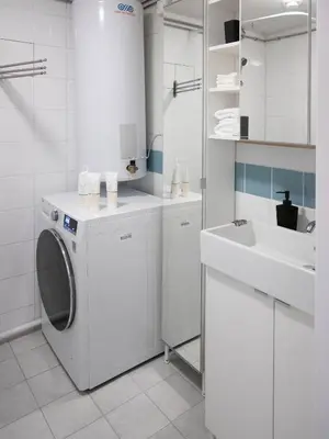 a white bathroom with a washing machine and a sink at Sentrumsvegen - Private Studio Apartment in Gol in Gol