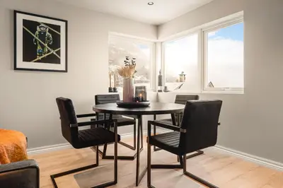 a dining room with a table and chairs and a window at Odda View - 4BR & 2BR & 1BR - B11 in Odda