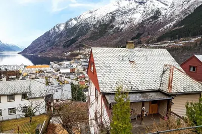 a view of a town with a snowy mountain at Odda View - 4BR & 2BR & 1BR - B11 in Odda
