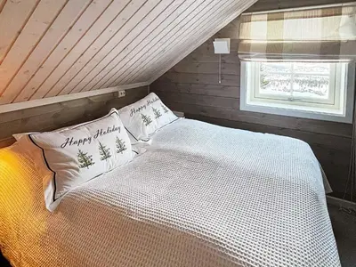 a bedroom with a white bed with pillows and a window at 7 person holiday home in Rauland-By Traum in Rauland