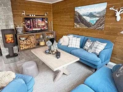 a living room with a blue couch and a fireplace at 7 person holiday home in Rauland-By Traum in Rauland
