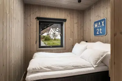 a bed in the corner of a room with a window at Wangen Apartments in Aurland