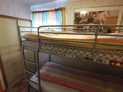 two bunk beds in a room with a mirror at Small Basement Apartment Private Entrance Nice View in Fitjar