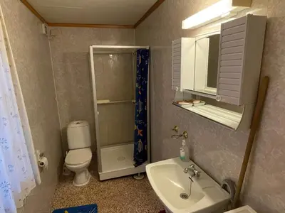 a small bathroom with a toilet and a sink at 8 person holiday home in Åkra-By Traum in Åkra