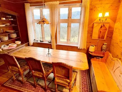 a dining room with a wooden table and chairs at 8 person holiday home in Åkra-By Traum in Åkra