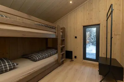 a bedroom with bunk beds in a cabin at High standard cabin close to the Flå city center in Flå
