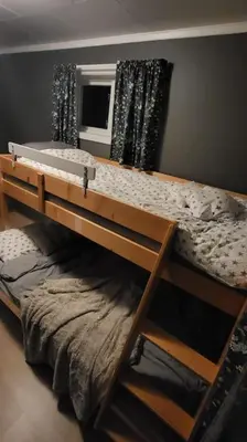 a bunk bed in a room with a window at Skogro ved Norefjell in Noresund