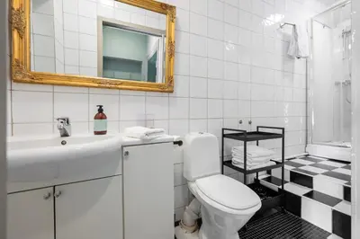 a bathroom with a toilet and a sink and a mirror at Jugend 1905 in Ålesund