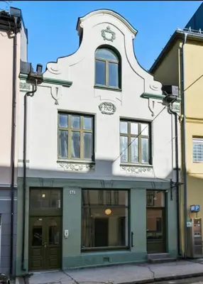 an old white building with a turret at Jugend 1905 in Ålesund