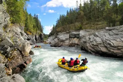 a group of people in a raft in a river at Cozy apartment near Besseggen with a private sauna in Randsverk