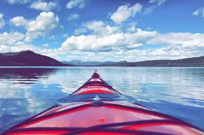 a view from the back of a kayak on a lake at Cozy apartment near Besseggen with a private sauna in Randsverk